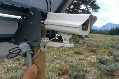 Camera and solar panel showing cables looped prior to entering conduit to allow for condensation or precipitation to drip outside of conduit. We later used a zip tie to secure them together more tightly. 